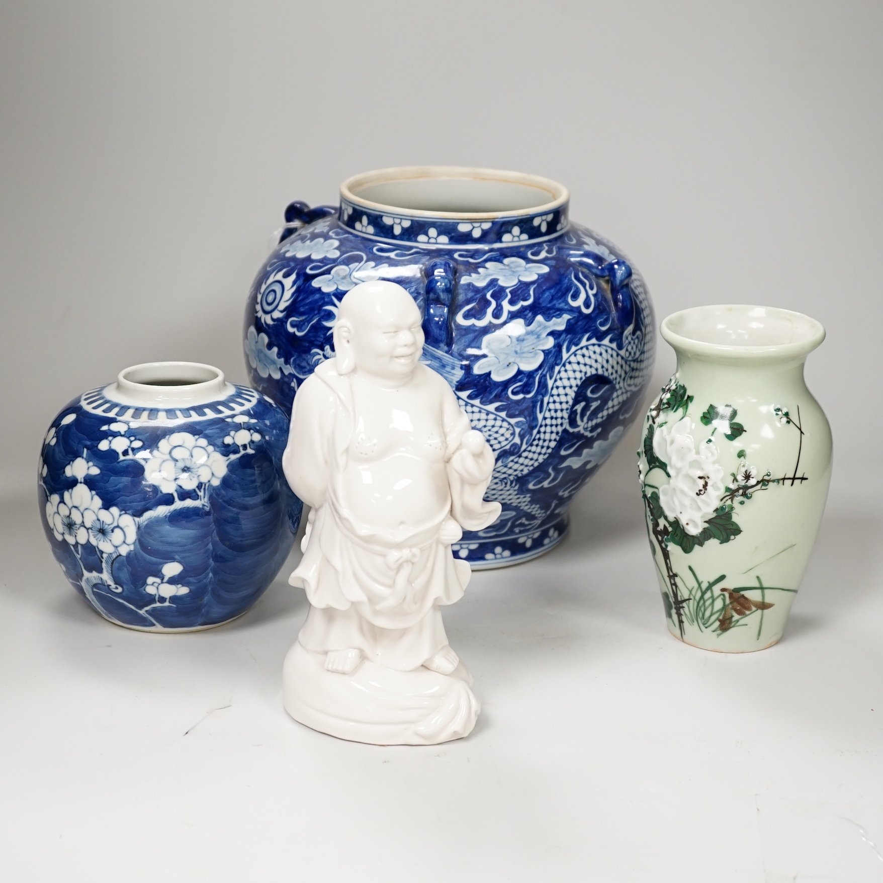 A group of Chinese ceramics including a celadon glazed vase, blue and white jar, white glazed figure and a jardiniere